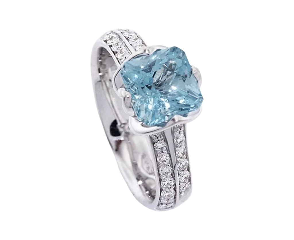Promise engagement ring in white gold with a central aquamarine and diamonds set on the band.