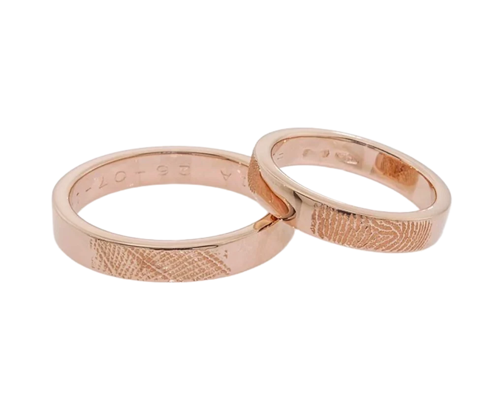 Handmade rose gold wedding rings with a bespoke texture created from the couple's fingerprints