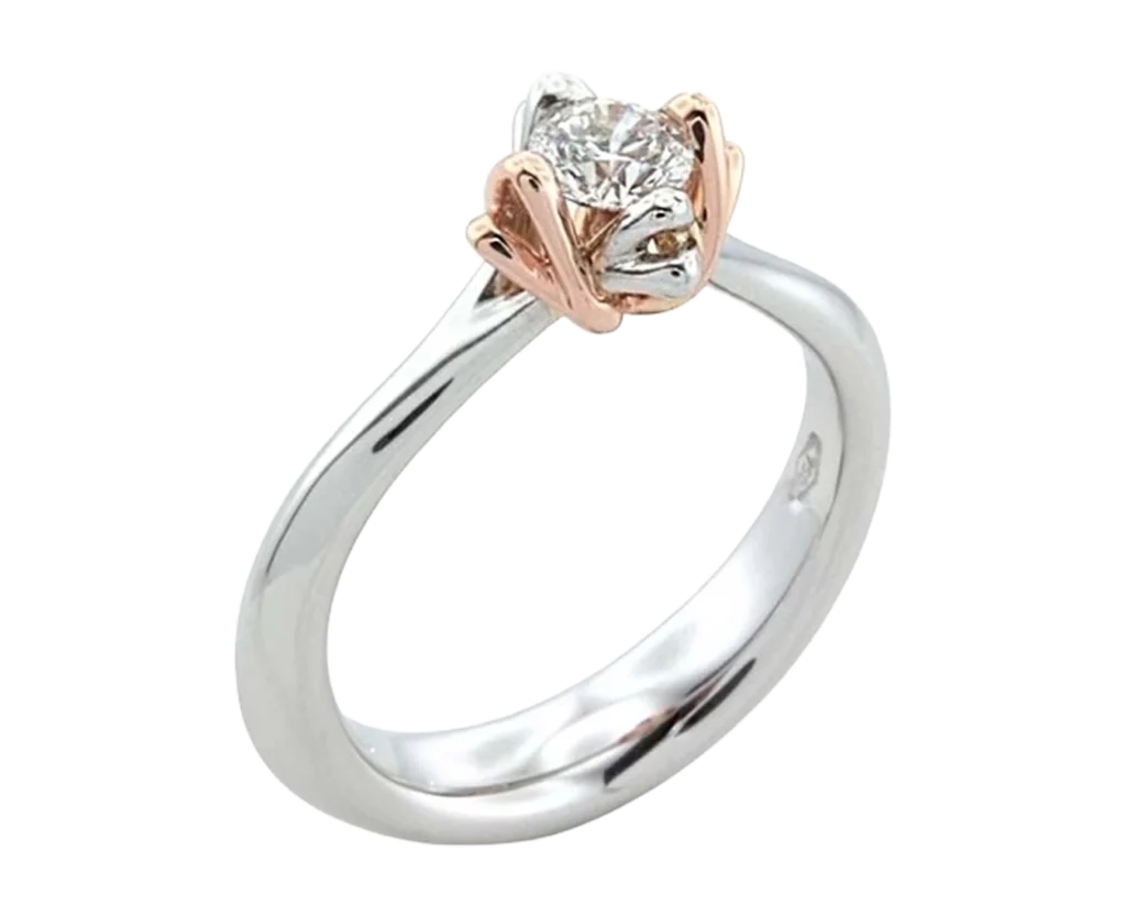 White gold solitaire engagement ring with a central diamond and a rose gold kiss-shaped setting