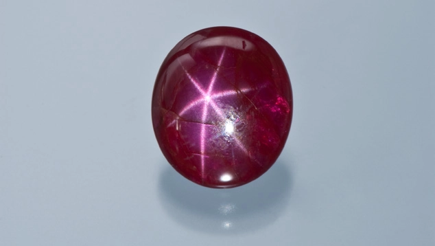 Cabochon red ruby with star effect